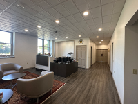 The Marywood president's office with a large wooden desk, four chairs in a square shape, Marywood-related objects on the wall