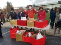 student at table provide gifts/cards to local children/teens