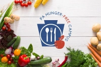 A white table filled with fruits and vegetables. The text 'PA Hunger-free campus' sits in the middle Marywood Designated as a PA Hunger-Free+ Campus