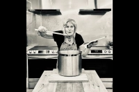 Keynote presenter Tannis Kowalchuk is picture over a large stockpot with a wooden spoon in her hand. Advocacy/Social Justice Day Focuses on Food Justice and Nourishing Community