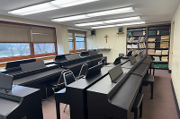 A room filled with several pianos.