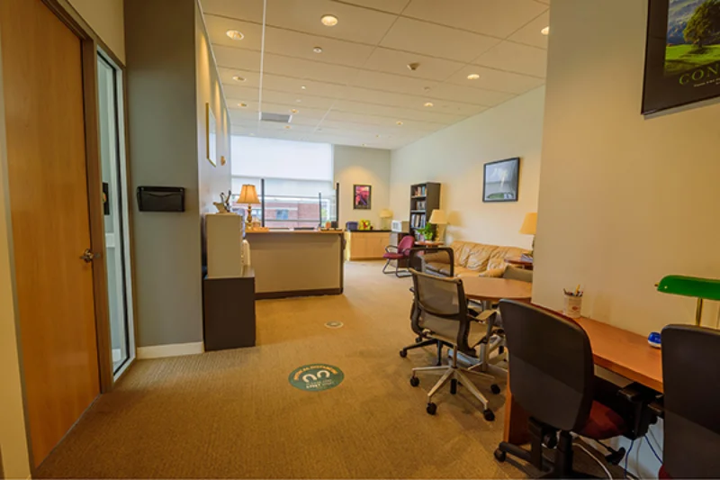 Couches and desks that fill the inside of the office of student success