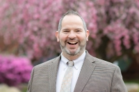 Dr. Jeff Kegolis is pictured in front of a tree with pink blossoms. Dr. Jeff Kegolis Recognized as Higher Education Trailblazer