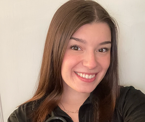 Closeup selfie of a young woman wearing a black jacket