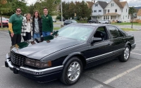 Marywood students stand near a classic Cadillac that was featured in the inaugural Crusin' for a Cause 2nd Annual Cruisin’ for a Cause Car Show to Benefit St. Joseph’s Center