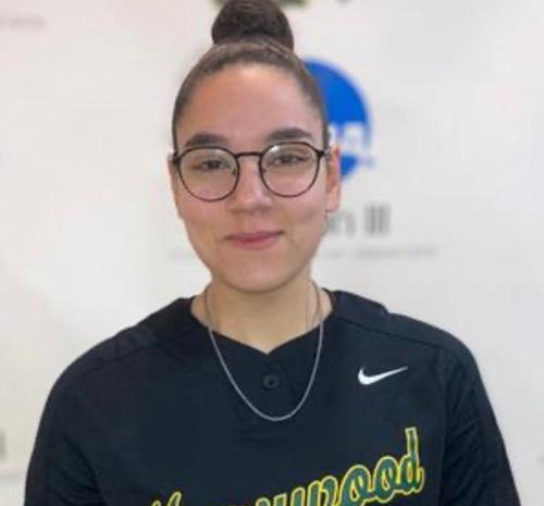 Young woman smiling wearing a marywood shirt with a bun in her hair and glasses