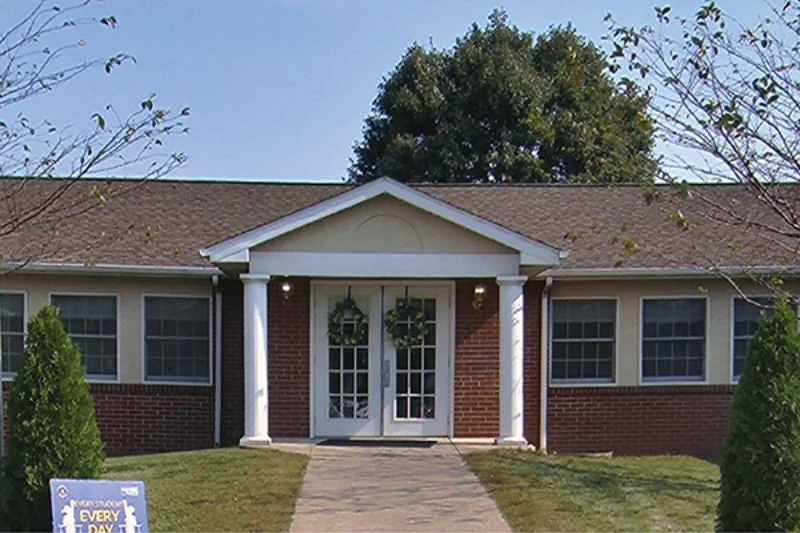 The front of the Marywood Fricchione early learning center with white doors and wreaths hanging from them