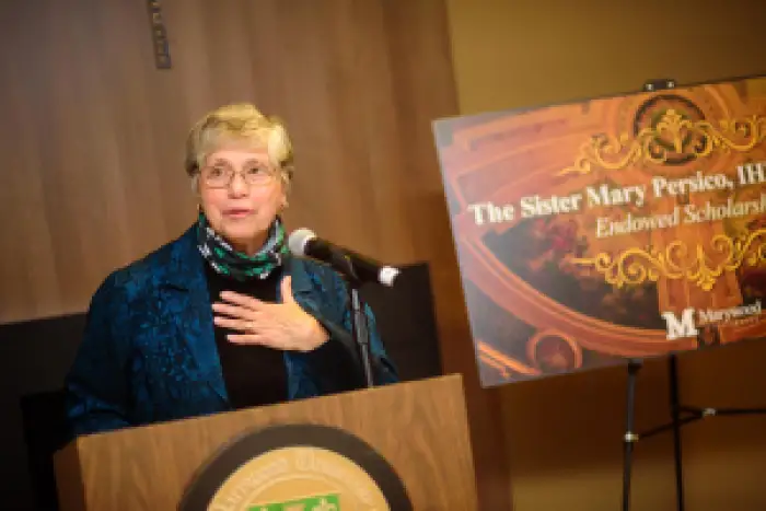 Sister Mary speaking in front of a crowd